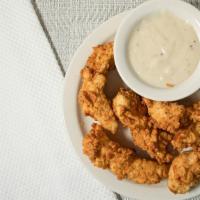 Chicken Tenders · Buttermilk dipped, hand battered chicken tenders served with choice of dipping sauce.