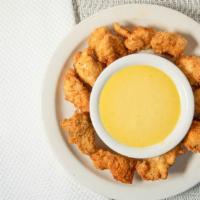 Chicken Poppers · Cajun chicken poppers served with cajun sauce.