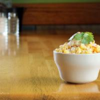 Mexican Street Corn · Tender corn kernels topped with mayonnaise, crumbled cotija cheese, chili powder and lime.
