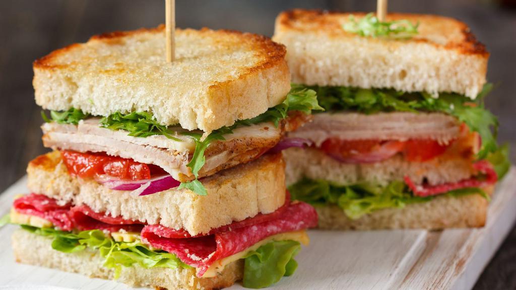 Grilled Turkey Club Sandwich · Mouthwatering House special sandwich prepared with Oven roasted turkey, bacon, melted cheddar cheese, mayo, lettuce, tomato and onion. Served on customer's choice of bread, with choice of a side.