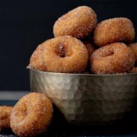Mini Donuts · 1 dozen hot fried mini donuts tossed in cinnamon and sugar.