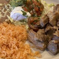 Carnitas · Traditional Mexican style fried pork served with rice, refried beans, lettuce, guacamole and...