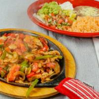 Fajitas · Grilled chicken, sautéed bell peppers, onions, and tomatoes. Served on a hot skillet. Served...