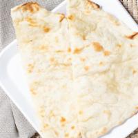 Naan · Flat leavened soft bread baked in clay oven.