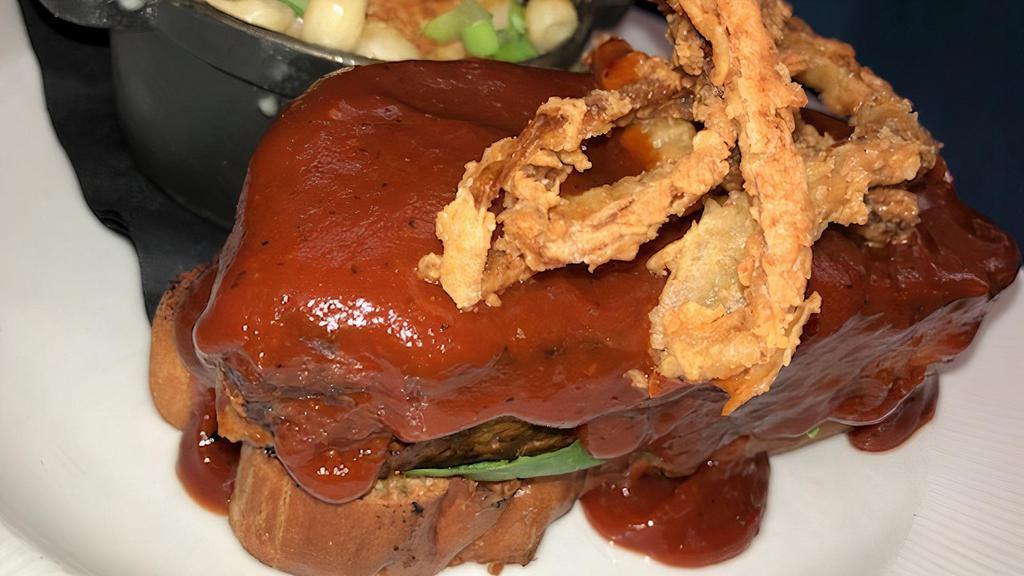 Meatloaf Sandwich · Blend of beef, pork, and bacon, smothered in spicy BBQ sauce, with fried onion strings; open-faced on Texas toast.