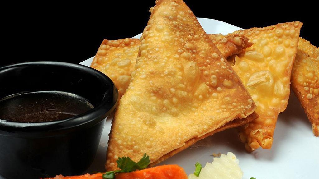Crab Wonton (4 Pc) · Crispy wonton shells filled with a blend of cheese, green onion, and crab meat: served with pickled vegetables.