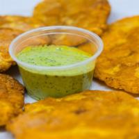 Tostones · crispy green plantains served with garlic butter