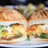 Breakfast Torta · A Traditional Mexican sandwich, 2 eggs scrambled served on a bolillo roll with refried beans...
