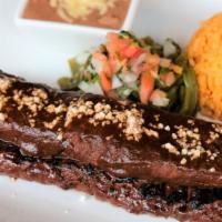 Tampiquena · 10oz marinated skirt steak served with a cheese mole enchilada cactus salad, mexican rice an...
