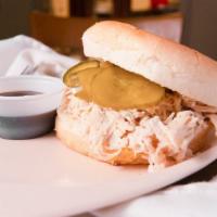 Pulled Chicken Sandwich · Our own pulled seasoned chicken, BBQ sauce and pickles on a bun.