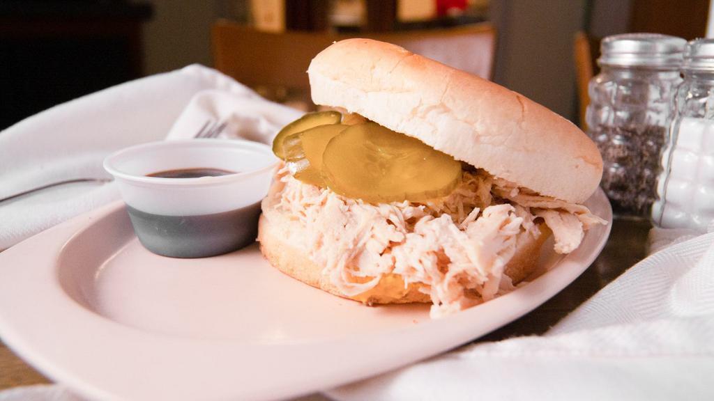 Pulled Chicken With Cheese · Our own pulled seasoned chicken, BBQ sauce, onions and pickles on a bun.