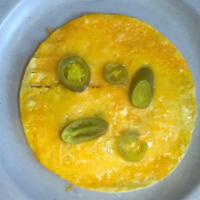 Original Corn With Jalapenos · A fried corn tortilla with melted cheese
and Jalapeno Sauce and Jalapenos