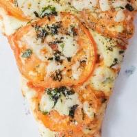 Margherita Slice · Topped with fresh basil and tomato slices, our Margherita Pizza will have you in pizza heaven.