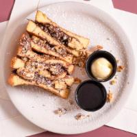 Banana Nut Stuffed Waffle · Nutella spread with bananas & walnuts topped with powdered sugar.