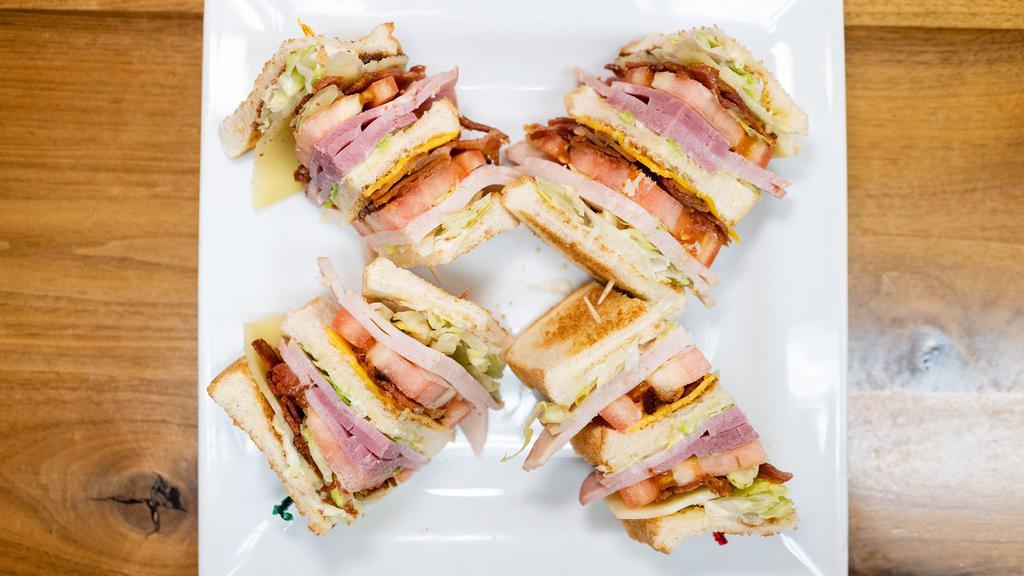 Club Sandwich · Customer favorite!  ham, turkey, hickory smoked bacon, lettuce, tomato, mayo, American & Swiss cheese on toast.