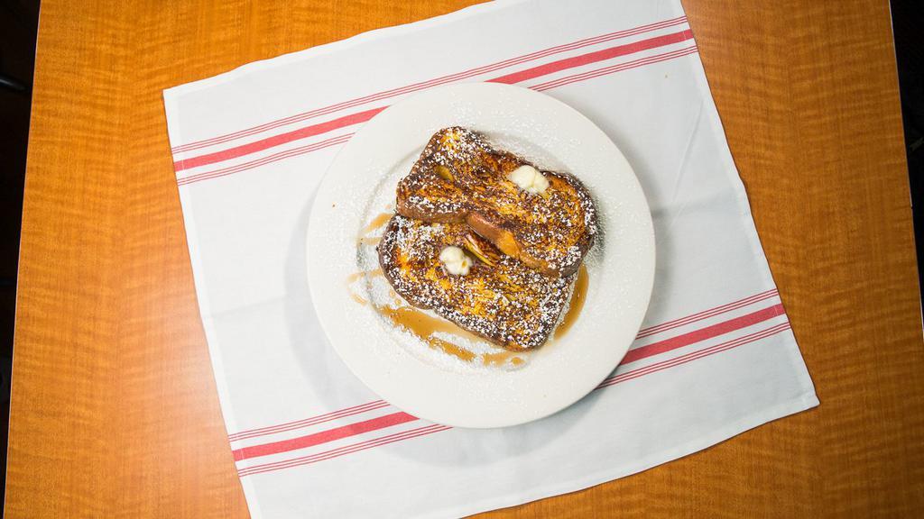 French Toast · Thick Texas toast topped with powdered sugar.