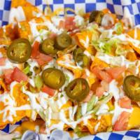 Dorinachos Loaded - Chicken Or Beef · A choice of meat - chicken or beef, dorito chips, nacho cheese, lettuce, tomatoes, sour crea...