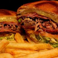 Cuban Sandwich · Village Tavern & Grill Signature Item.  Pulled pork, salami, ham, sliced pickles, Swiss chee...