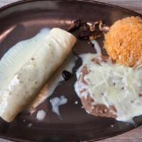Burrito Fajitas · Tortillas stuffed with grilled onions and bell peppers and a choice of steak or chicken, cov...