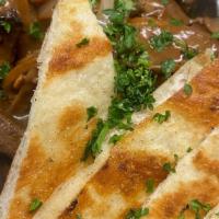 Steak Bites · with Grilled Mushroom, Onion, and Garlic Pita Bread.