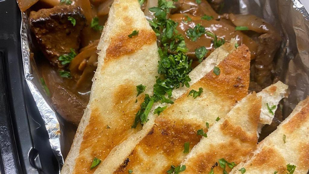 Steak Bites · with Grilled Mushroom, Onion, and Garlic Pita Bread.