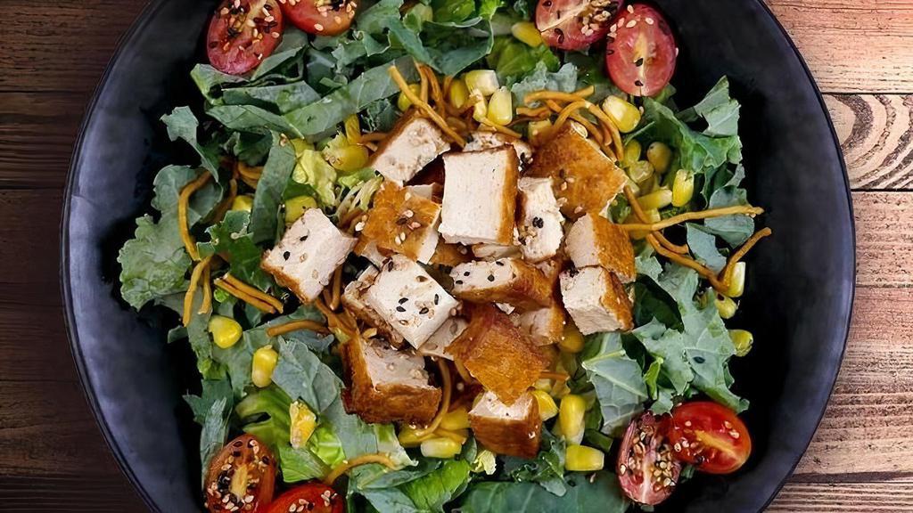 Sesame Ginger Salad W/ Tofu · Napa cabbage, romaine, and kale tossed in our house made sesame-ginger dressing with crispy ramen noodles, sweet corn, and cherry tomatoes. Topped with fried marinated tofu.
