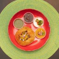 Khasta Kachori Chaat · Crispy puffed rice pastry, filled with potatoes, onions, sprouts and lentils topped with yog...