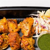 Chicken Tikka (6 Pcs) · Chicken pieces marinated with yogurt , garlic, ginger and spices, grilled. Served with tamar...