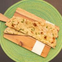 Butter Naan · Leavened Indian bread cooked in traditional tandoor oven glazed with clarified butter. (Alle...