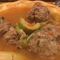 Albondigas · bowl of traditional mexican meatball stew with zucchini, potatos, onions, carrots, served wi...