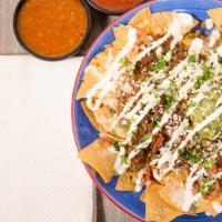 Nachos · Gluten-free. Chips, beans, the meat of choice, guacamole, sour cream, cheese, tomato, onion,...