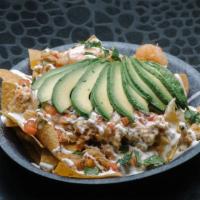Crab And Shrimp Nachos. · Real crab meat with shrimp sautéed in a spicy garlic butter and sour cream sauce topped with...