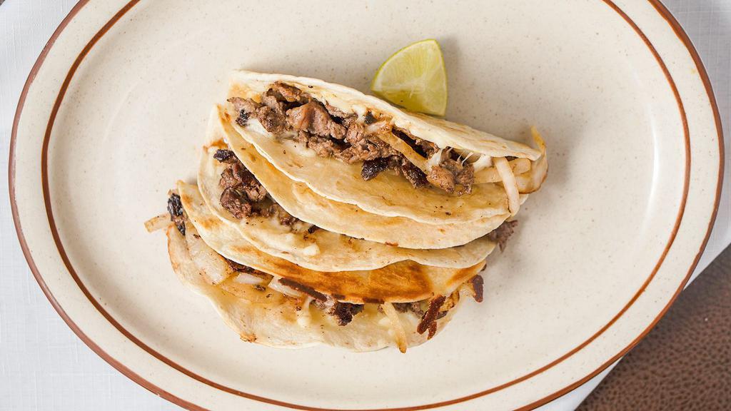 Special Taco · One super taco in a flour tortilla, bacon onion and melted cheese. Meat of your choice.