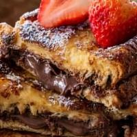 Nutella Stuffed French Toast · 3 Nutella stuffed French toast, served with strawberries and chocolate syrup.