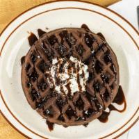 Oreo Waffles · Oreo-made waffle topped with chocolate syrup, Oreo crumbles and whipped cream.