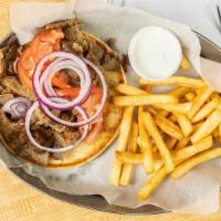 Gyro Sandwich  · Gyro from the spit  Tomatoes Onions serve  in pita Bread and home made  cucumber sauce