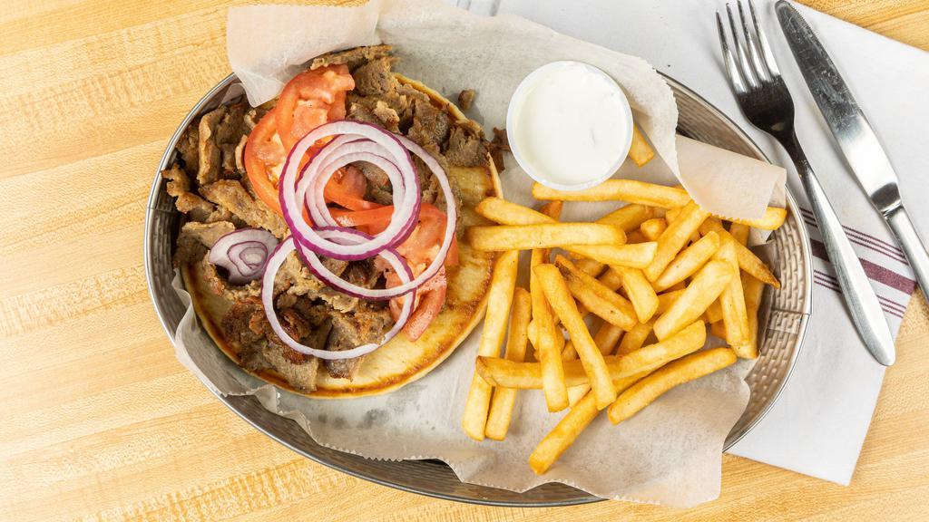 Gyro Sandwich  · Gyro from the spit  Tomatoes Onions serve  in pita Bread and home made  cucumber sauce