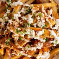 Greek Fries · Greek twist to your fresh cut fries - topped with feta cheese and house sauce