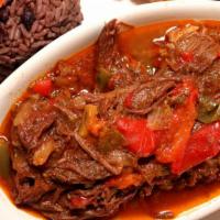Ropa Vieja · Flank steak shredded and simmered in a homemade sauce of tomato and sweet peppers.