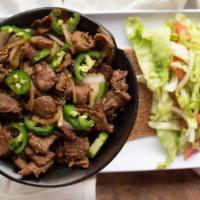 Zilzil Tibs · Beef tenderloin, onion, jalapeños mixed bell peppers and Ethiopian herbs sauteed to perfecti...