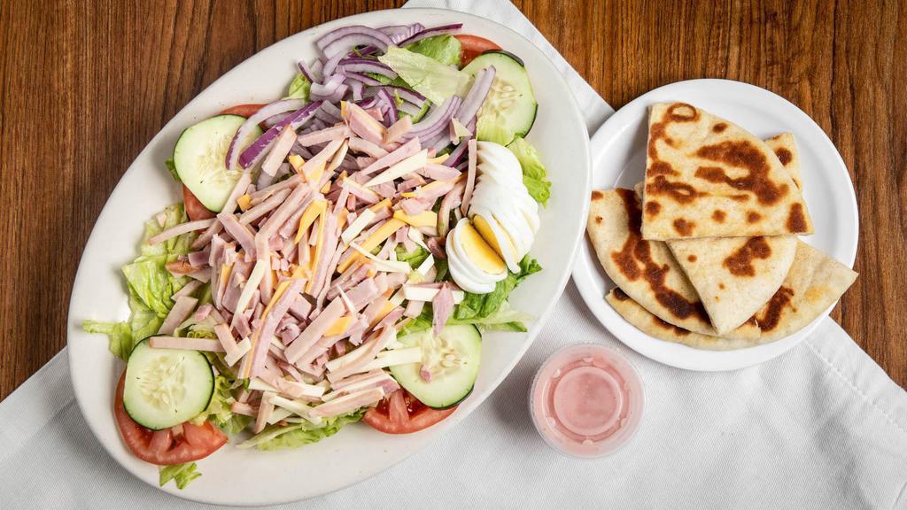 Chef’S Salad · Ham, Turkey, American, and Swiss cheese, lettuce, tomatoes, cucumbers, hard boiled egg and onion, served with pita bread.