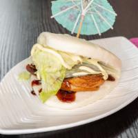 Chashu Pork Bun (1 Piece) · Steamed bun, lettuce, roasted pork belly, Japanese mayo and house made sauce.