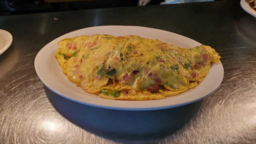 The Omelette · Three egg omelette stuffed with your choice of any four items from below.