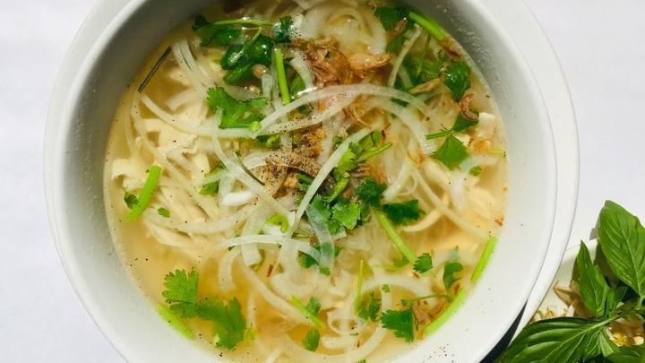 Chicken Pho · White and dark meat chicken simmered in chicken broth. Then poured over rice noodles, onion and herbs. Served with a plate of other herbs and lime. Add hoisin sauce or sriracha for extra flavor.