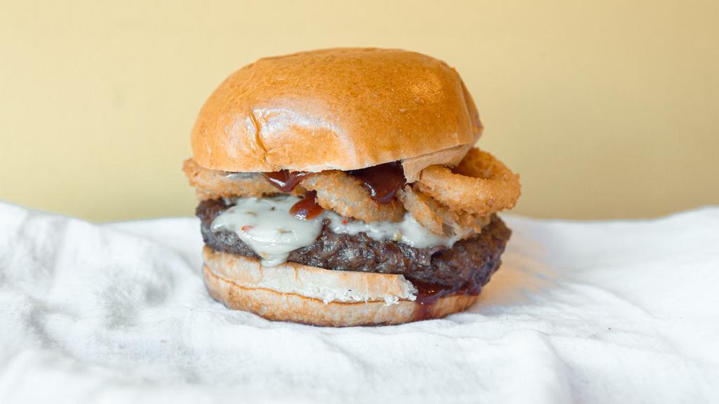 Bbq Burger · Choice of protein (1/2 pound Angus patty, chicken breast or chipotle black bean patty) + Onion Rings + BBQ Sauce + Pepper Jack Cheese + Pickles.