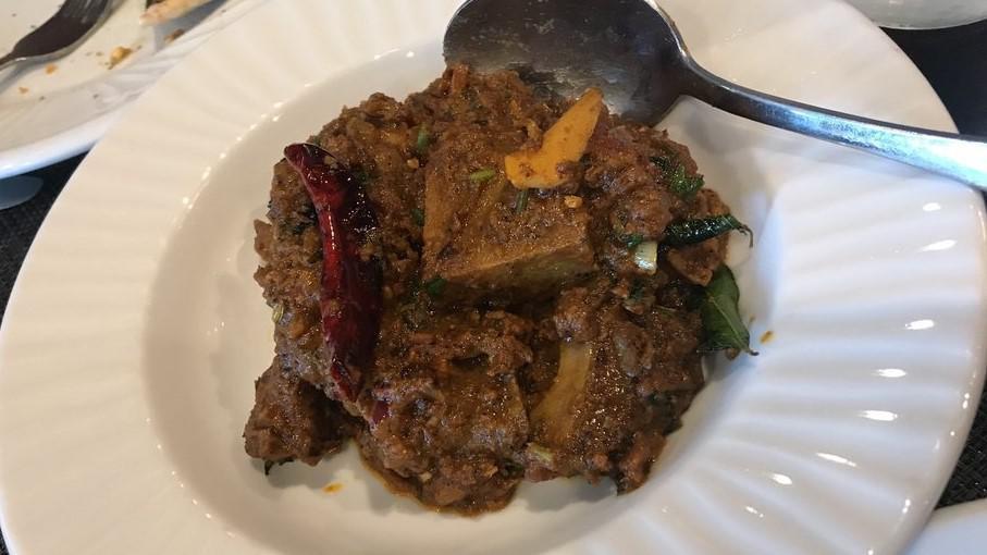 Goat Sukkha · Bone in goat cooked with onion tomatoes tempered with south Indian spices and coconut powder.