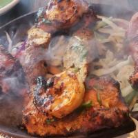 Tandoori Quadruple Play · Combination of four grilled delicacies-seekh kebab, malai chicken, tandoori chicken and shri...