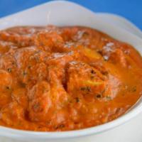 Chicken Tikka Masala · Tender chicken roasted in clay oven cooked with chopped tomato and onion gravy and topped wi...