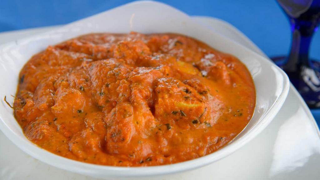 Chicken Tikka Masala · Tender chicken roasted in clay oven cooked with chopped tomato and onion gravy and topped with bell peppers.