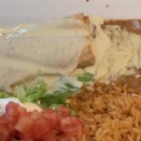 Lunch Chimichanga · One chimichanga stuffed with choice of chicken or beef and topped with cheese dip. Served wi...